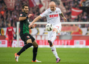 COLOGNE, GERMANY - NOVEMBER 26: Halil Altintop (L) of Augsburg and Konstantin Rausch (R) of Koeln in action during the Bundesliga match between 1. FC Koeln and FC Augsburg at RheinEnergieStadion on November 26, 2016 in Cologne, Germany.