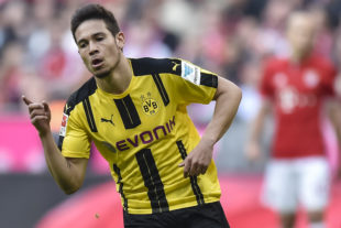 Dortmund's Portuguese defender Raphael Guerreiro celebrate scoring the 2-1 goal during the German first division Bundesliga football match FC Bayern Munich v BVB Borussia Dortmund in Munich, southern Germany, on April 8, 2017.