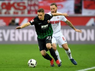 Augsburg´s midfielder Dominik Kohr and Cologne's midfielder Marco Hoeger (R) vie for the ball during the German first division Bundesliga football match between 1 FC Cologne and FC Augsburg in Cologne, western Germany, on November 26, 2016. 