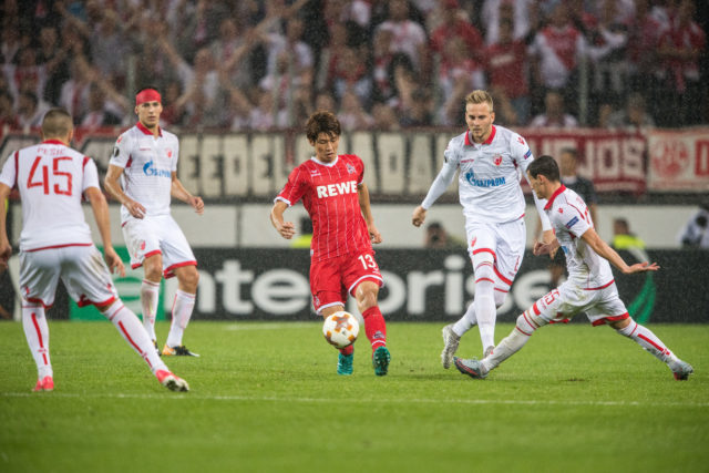 COLOGNE, GERMANY - SEPTEMBER 28: Yuya Osako of Koeln acts against the defense of Belgrade during the UEFA Europa League group H match between 1. FC Koeln and Crvena Zvezda at RheinEnergieStadion on September 28, 2017 in Cologne, Germany. 