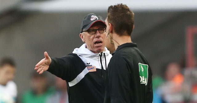 COLOGNE, GERMANY - SEPTEMBER 20: Peter Stoeger, coach of Koeln, argues with the fourth official Christian Bandurski during the Bundesliga match between 1. FC Koeln and Eintracht Frankfurt at RheinEnergieStadion on September 20, 2017 in Cologne, Germany. (Photo by Christof Koepsel/Bongarts/Getty Images)