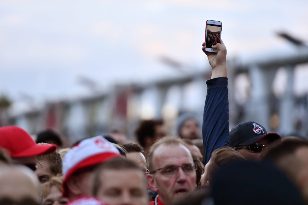 LONDON, ENGLAND - SEPTEMBER 14: An FC Koeln fan takes a picture of his fellow supporters as they are held outside the stadium by police prior to the UEFA Europa League group H match between Arsenal FC and 1. FC Koeln at Emirates Stadium on September 14, 2017 in London, United Kingdom. (Photo by Dan Mullan/Getty Images)