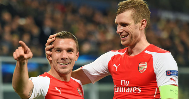 Arsenal's Polish-born German striker Lukas Podolski (L) celebrates with Arsenal's German defender Per Mertesacker after scoring during a UEFA Champions League group stage football match Anderlecht vs Arsenal at the Constant Vanden Stock stadium in Anderlecht on October 22, 2014. AFP PHOTO / EMMANUEL DUNAND (Photo credit should read EMMANUEL DUNAND/AFP/Getty Images)