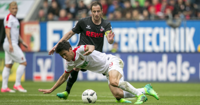 AUGSBURG, GERMANY - APRIL 15: Ja-Cheol Koo of FC Augsburg battles for the ball during the Bundesliga match between FC Augsburg and 1. FC Koeln at WWK Arena on April 15, 2017 in Augsburg, Germany. (Photo by Jan Hetfleisch/Bongarts/Getty Images)