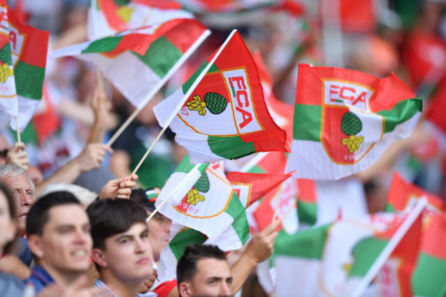 AUGSBURG, GERMANY - AUGUST 26: FC Augsburg supporters wave flags during the Bundesliga match between FC Augsburg and Borussia Moenchengladbach at WWK-Arena on August 26, 2017 in Augsburg, Germany. (Photo by Sebastian Widmann/Bongarts/Getty Images)
