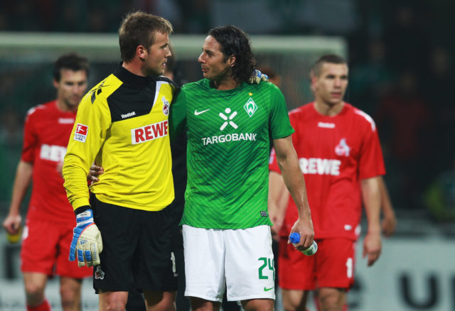 BREMEN, GERMANY - NOVEMBER 05: Claudio Pizarro of Bremen and Michael Rensing of Koeln chat after the Bundesliga match between Werder Bremen and 1. FC Koeln at Weser Stadium on November 5, 2011 in Bremen, Germany. (Photo by Joern Pollex/Bongarts/Getty Images)